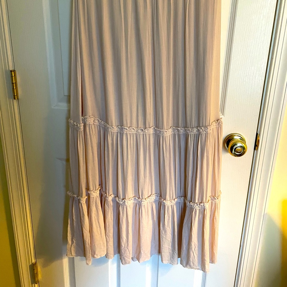 Beige ankle-length skirt.